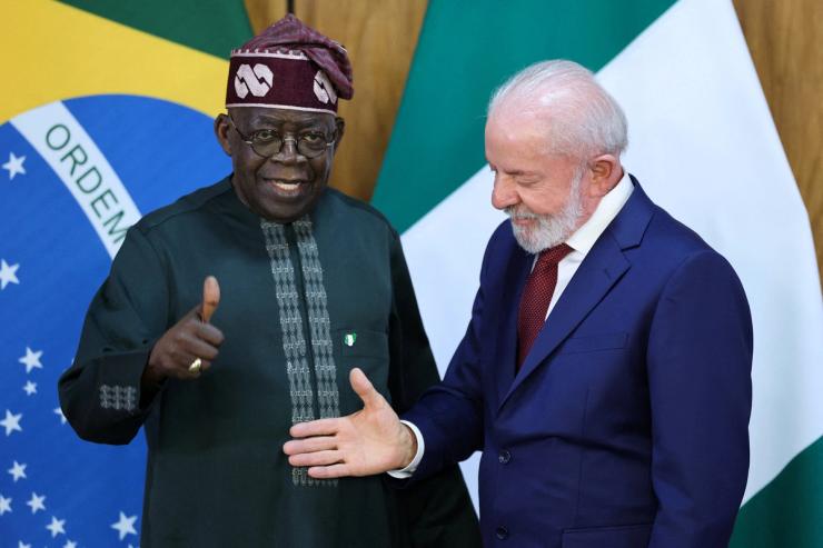 Nigeria’s President Bola Tinubu gestures next to Brazil’s President Luiz Inacio Lula da Silva