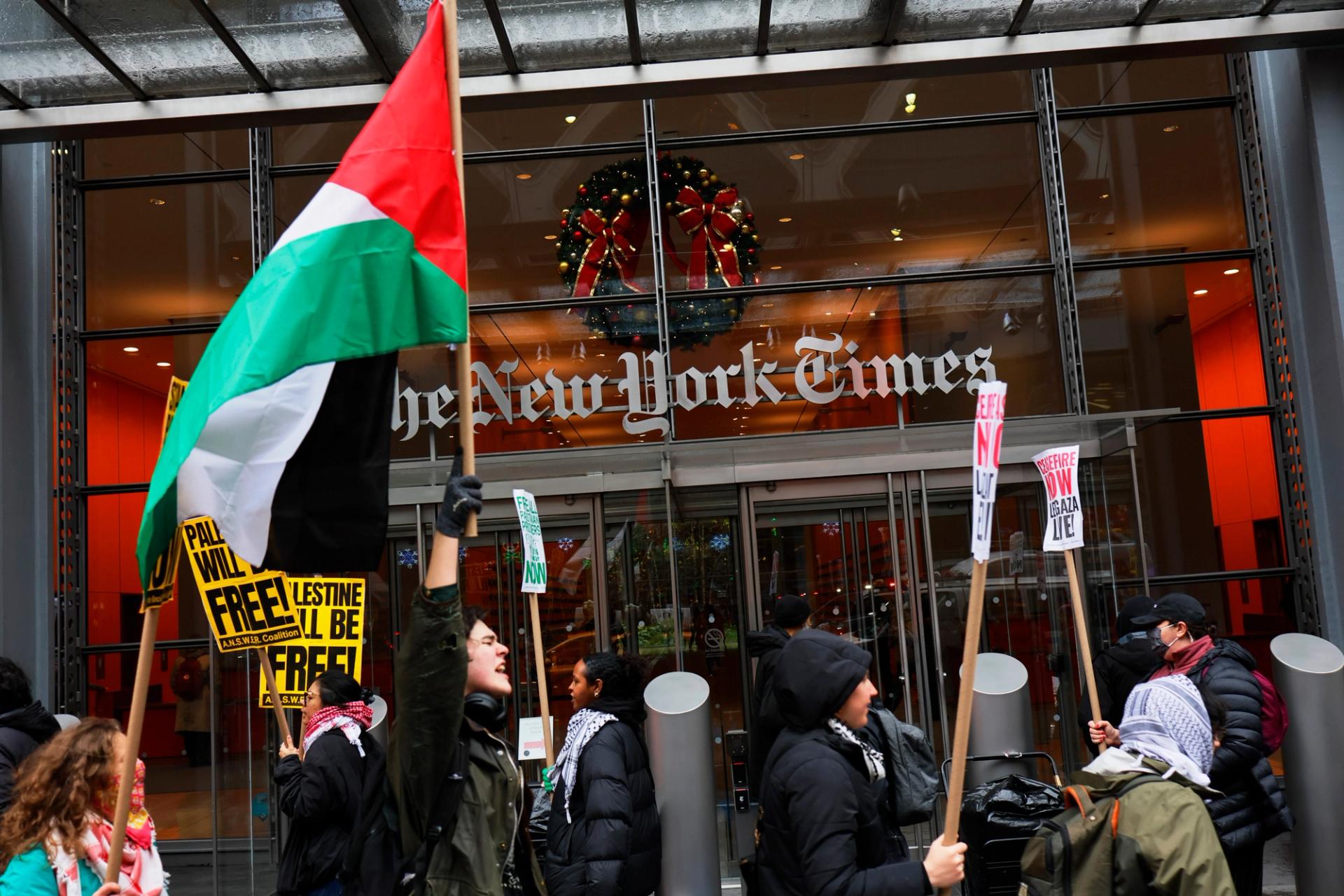 Pro-Palestinian protestors gather outside of the New York Times building to protest the newspaper's coverage of the Israel-Hamas war on December 11, 2023.