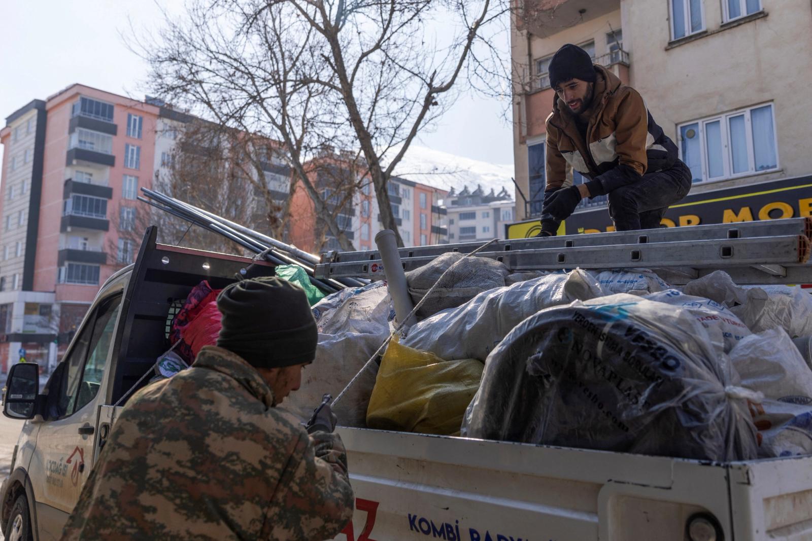 People load their belongings on a truck in the aftermath of a deadly earthquake in Elbistan