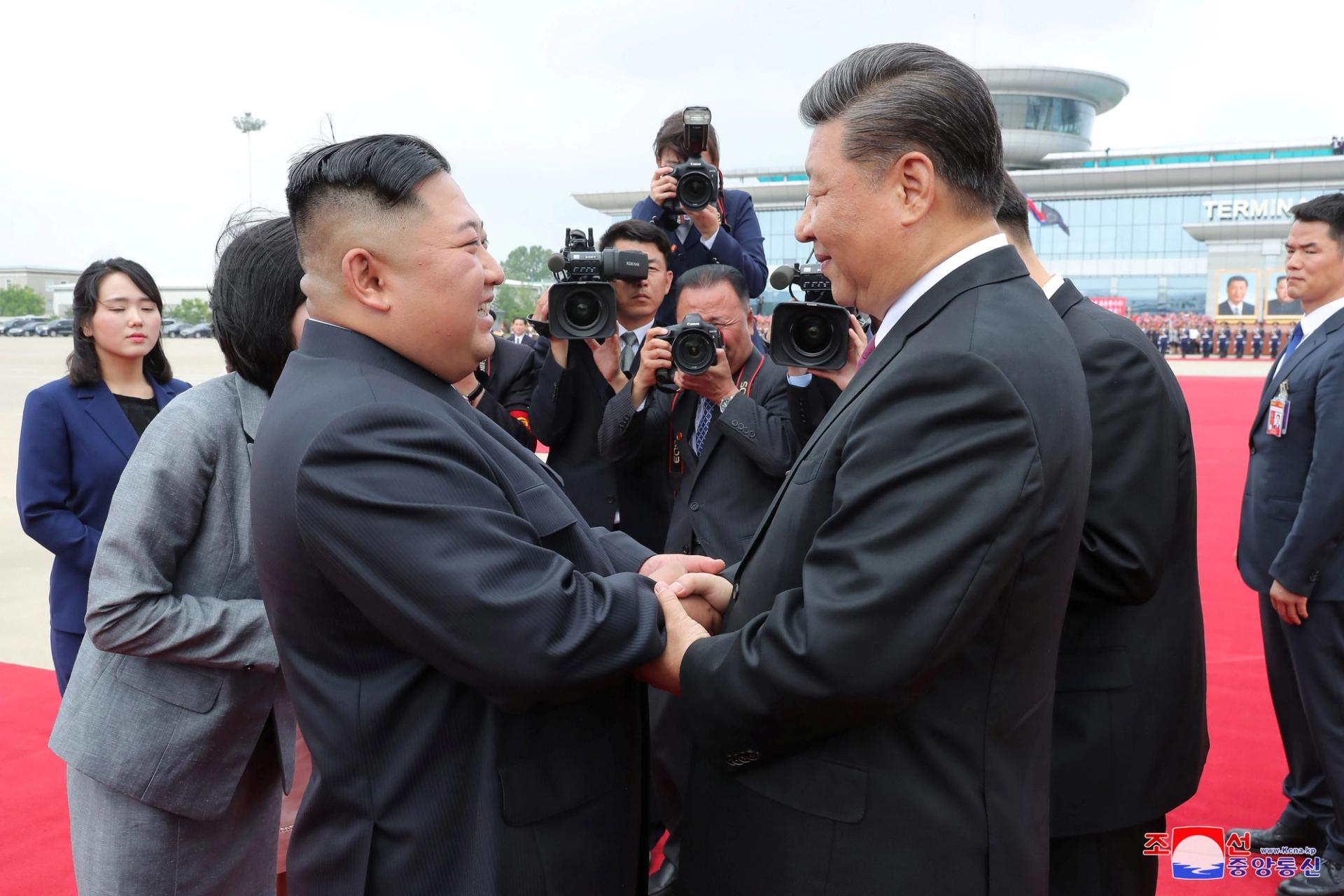 North Korean leader Kim Jong Un shakes hands with Chinese President Xi Jinping during Xi's visit in Pyongyang.