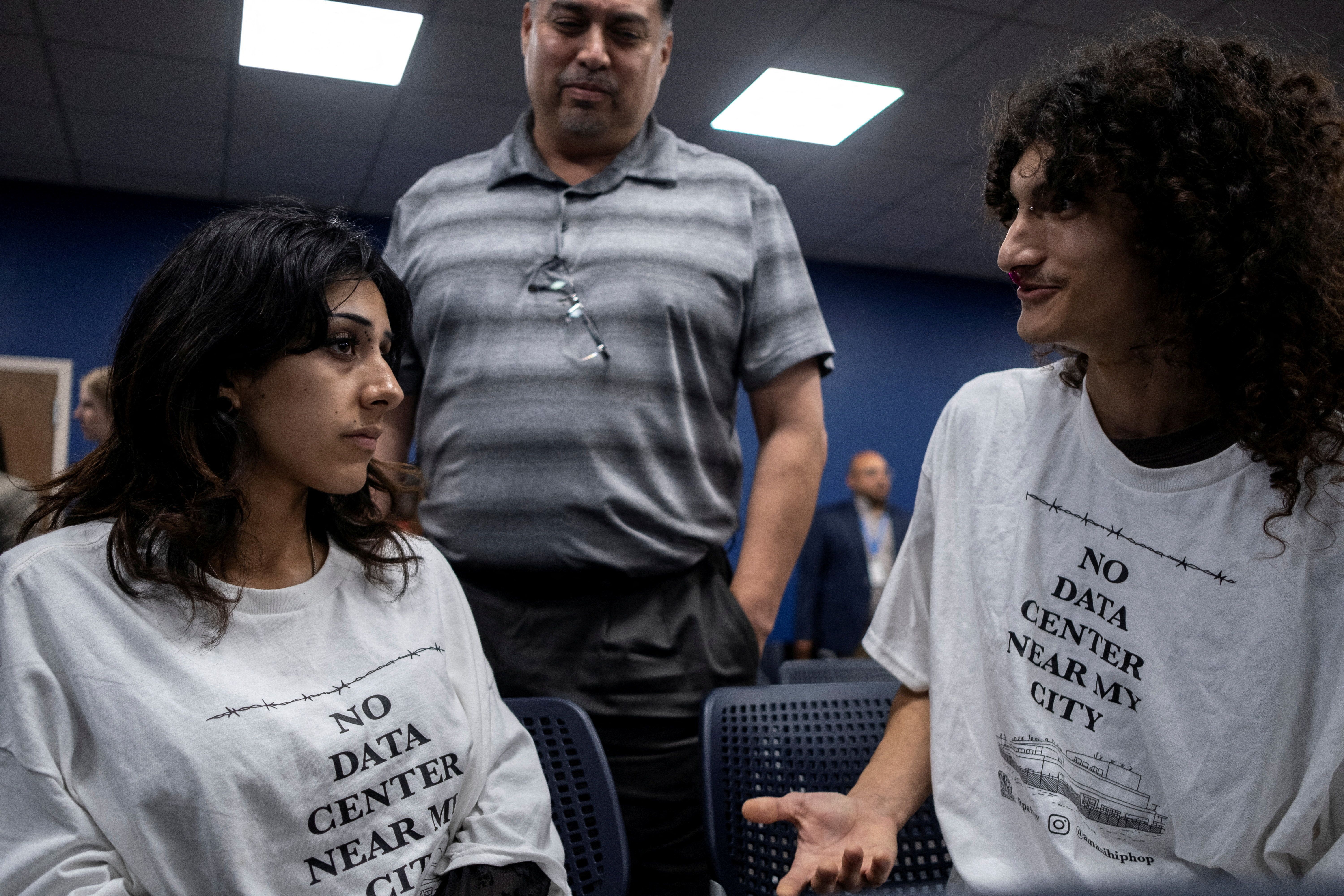Daya Lopez, Luis Valdespino and Jon Villegas attend a Harlingen City Commission meeting regarding a data centre being proposed by a subsidiary of Eneus Energy in Harlingen, Texas, U.S