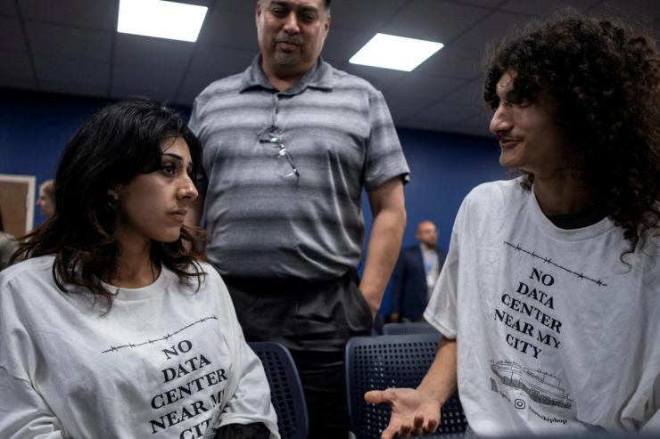 Daya Lopez, Luis Valdespino and Jon Villegas attend a Harlingen City Commission meeting regarding a data centre being proposed by a subsidiary of Eneus Energy in Harlingen, Texas, U.S