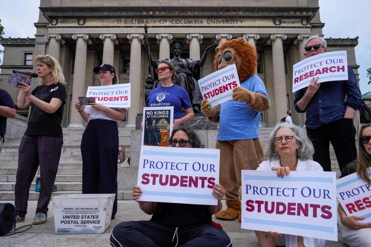 Members of the Columbia faculty and staff protest against the university’s policies