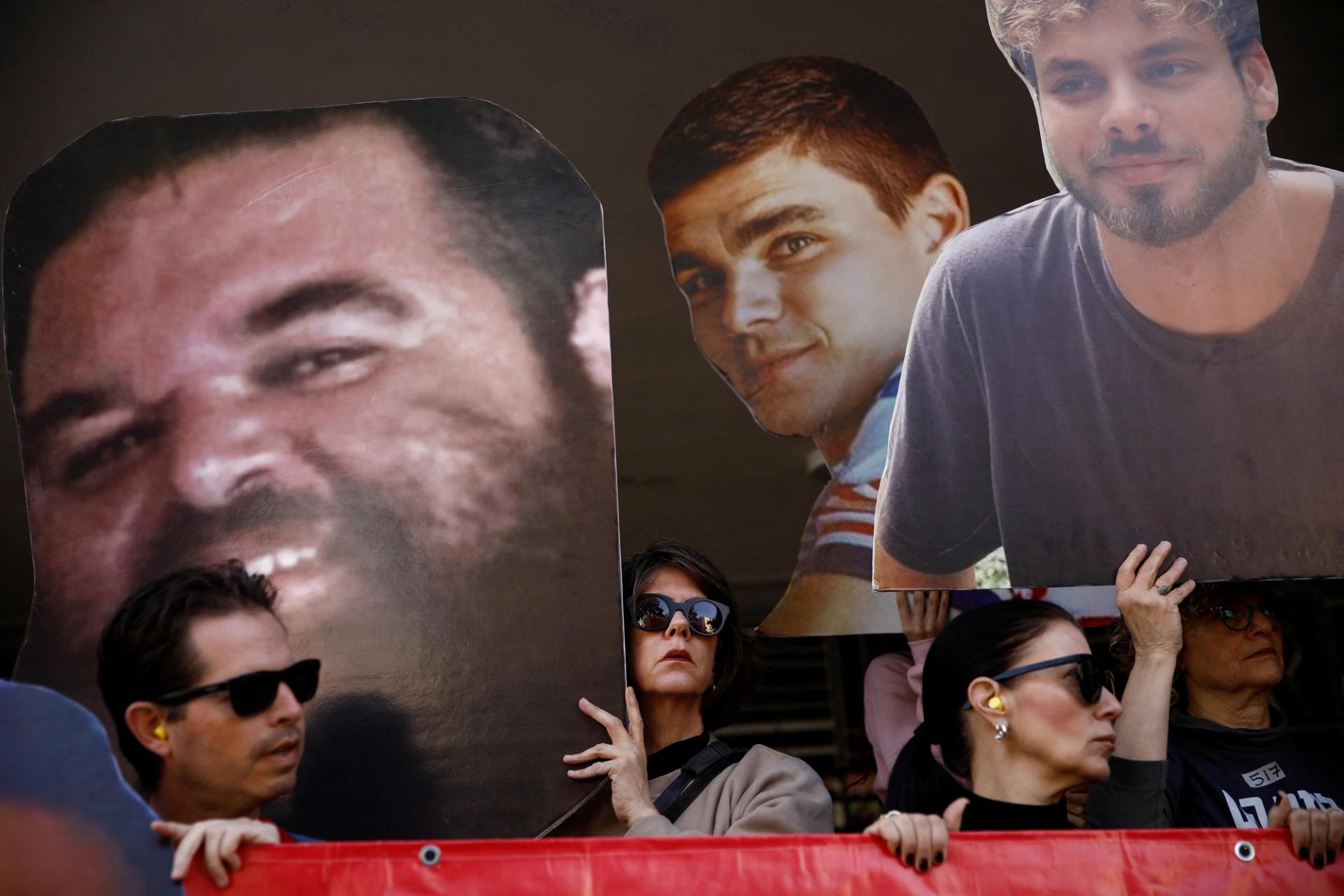 Protesters hold cutout pictures of hostages during a demonstration demanding the immediate return of hostages in Tel Aviv, Israel.