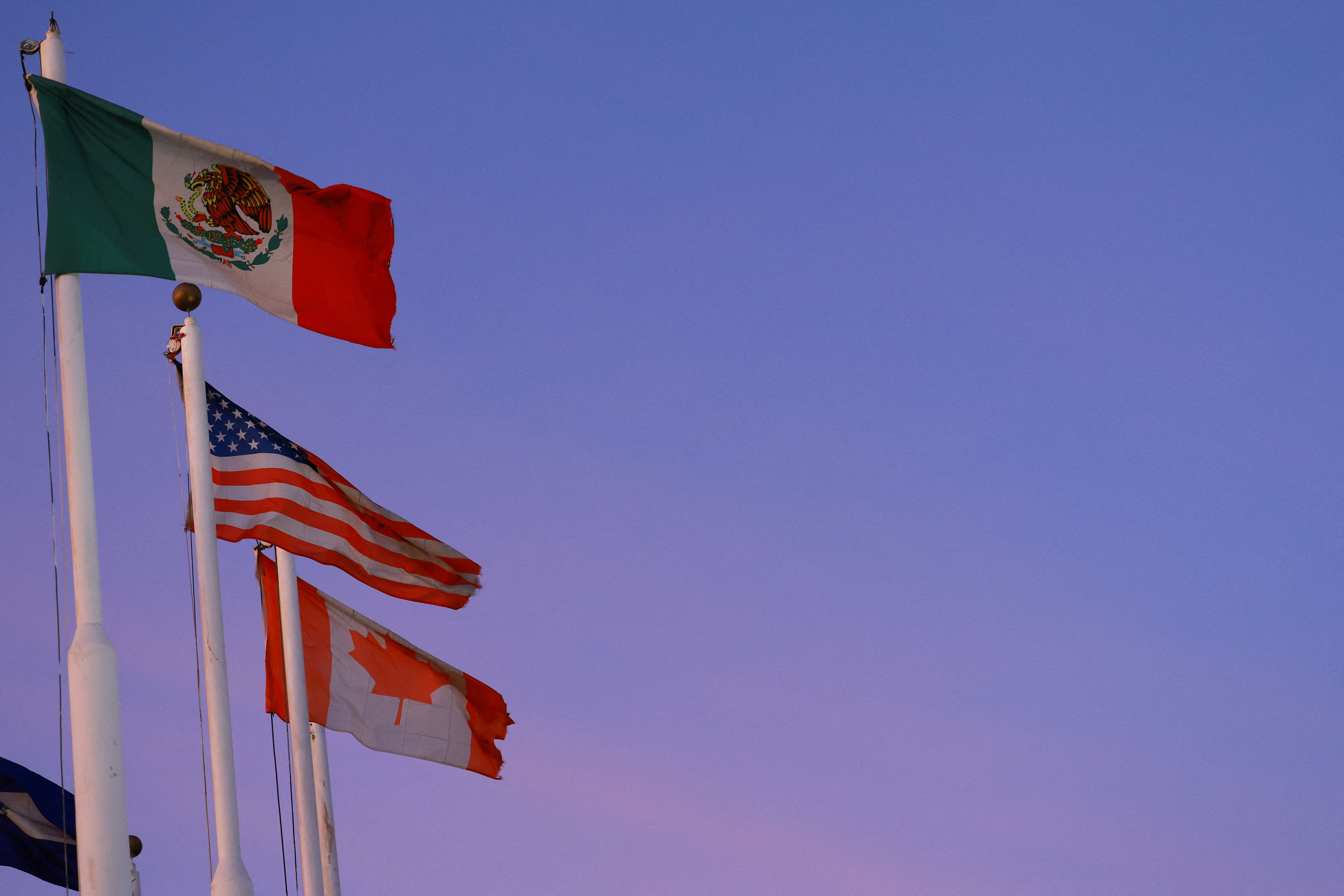 The flags of Mexico, the United States and Canada.