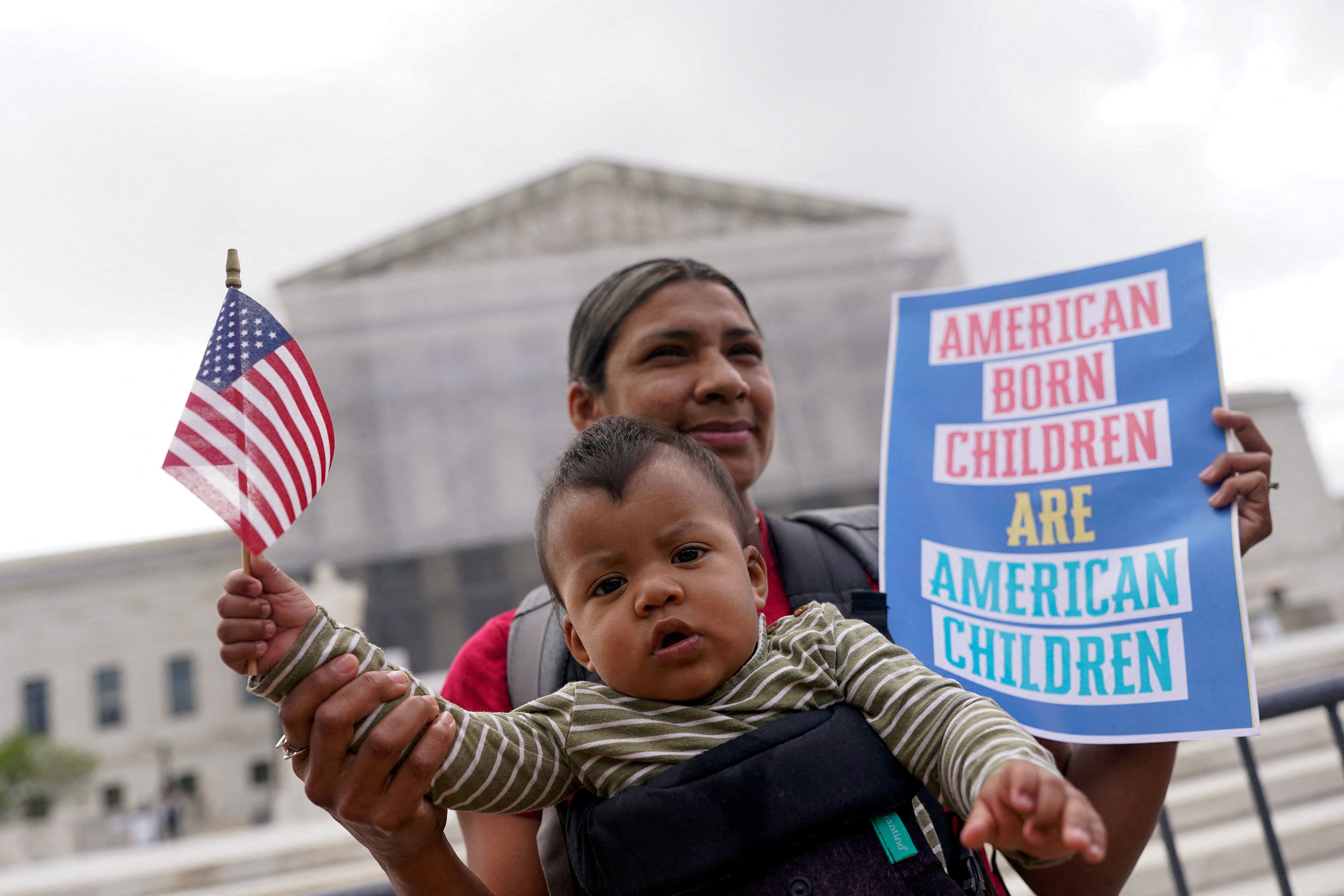 Olga Urbina carries baby Ares Webster as demonstrators rally on the day the Supreme Court justices hear oral arguments over U.S. President Donald Trump’s bid to broadly enforce his executive order to restrict automatic birthright citizenship.
