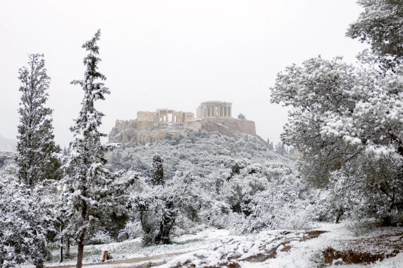 A view of the Parthenon temple atop the Acropolis hill during snowfall in Athens, Greece, February 6, 2023.