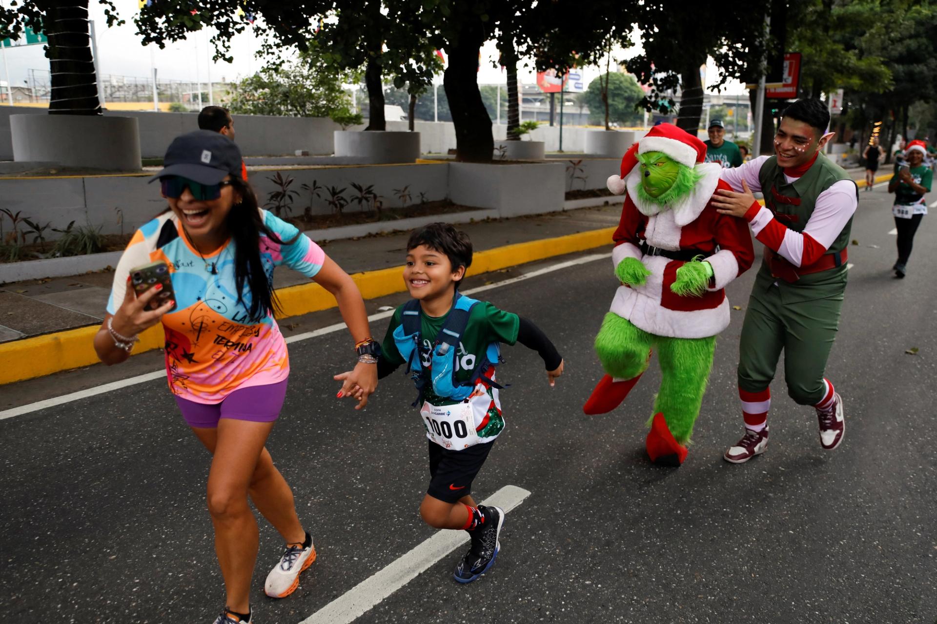 A man dressed as The Grinch takes part in the Santa Run 10-kilometre race, in Caracas, Venezuela, December 17, 2023.