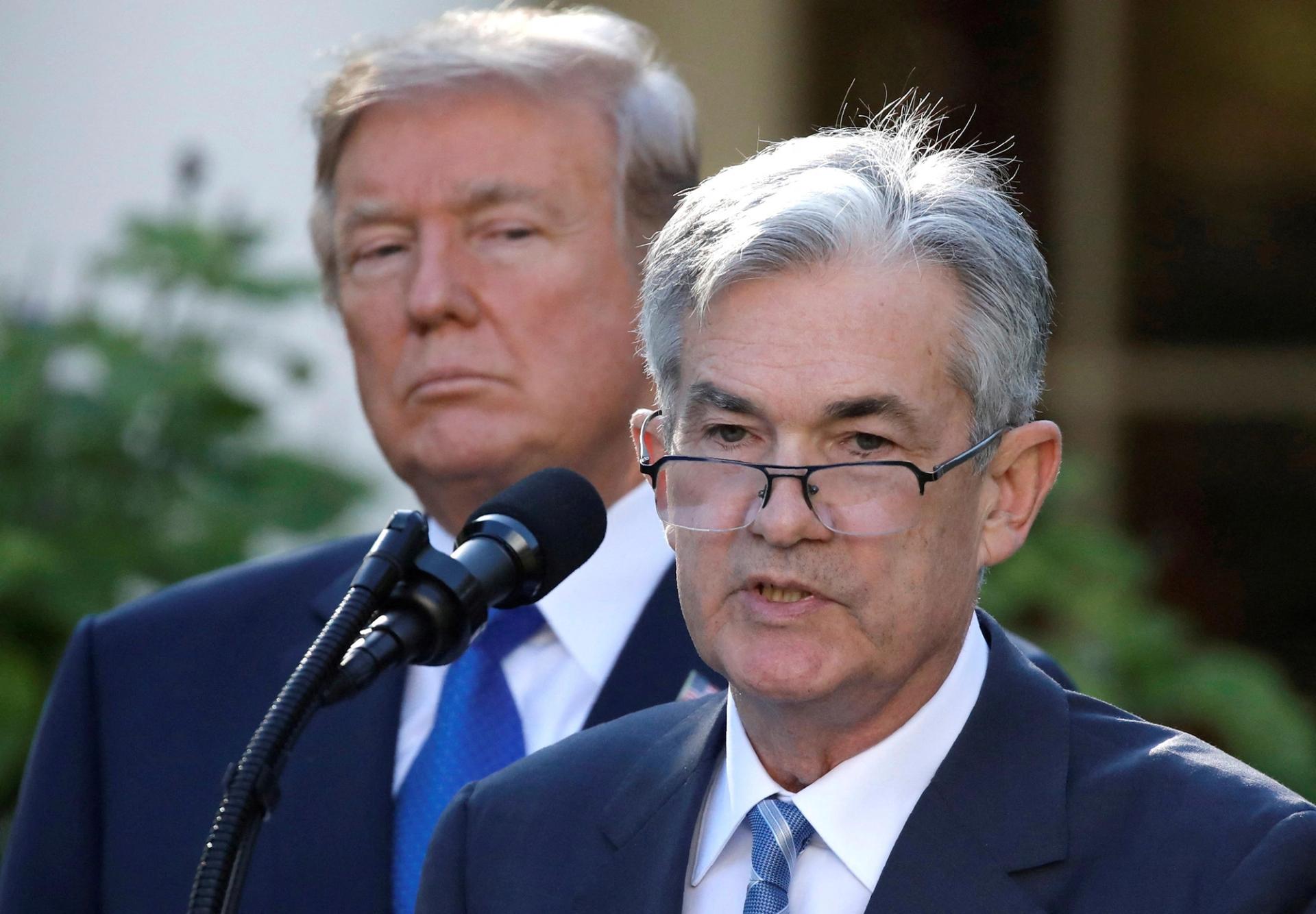 US President Donald Trump standing behind US Federal Reserve chairman Jerome Powell