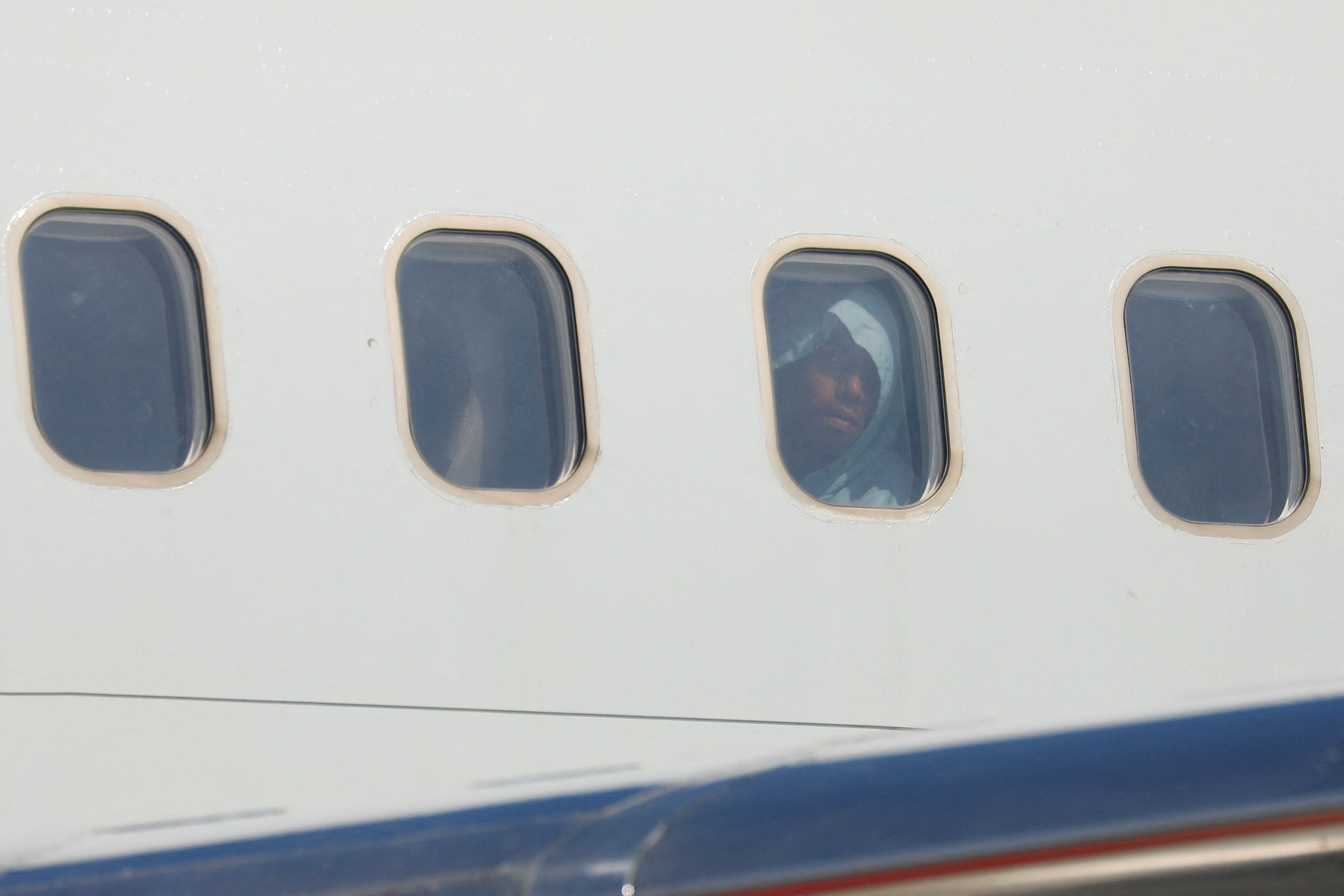 Venezuelan migrants react after arriving on a deportation flight from the United States.