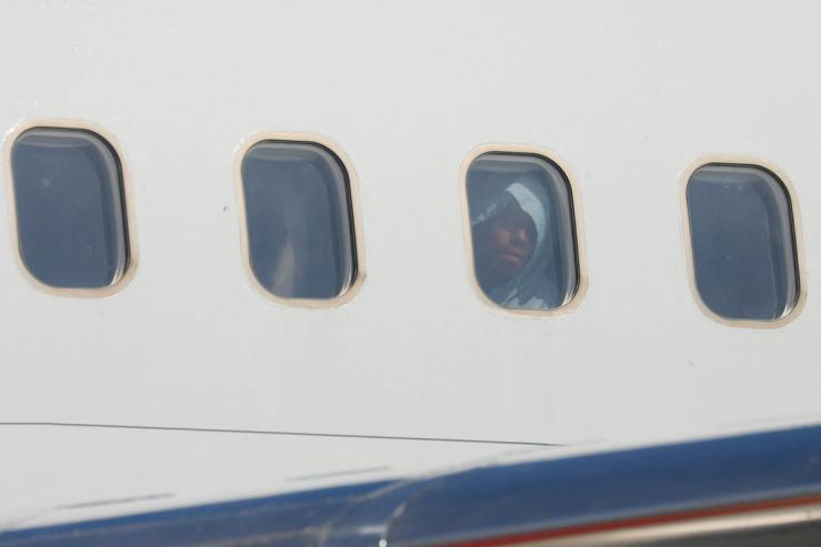 Venezuelan migrants react after arriving on a deportation flight from the United States.
