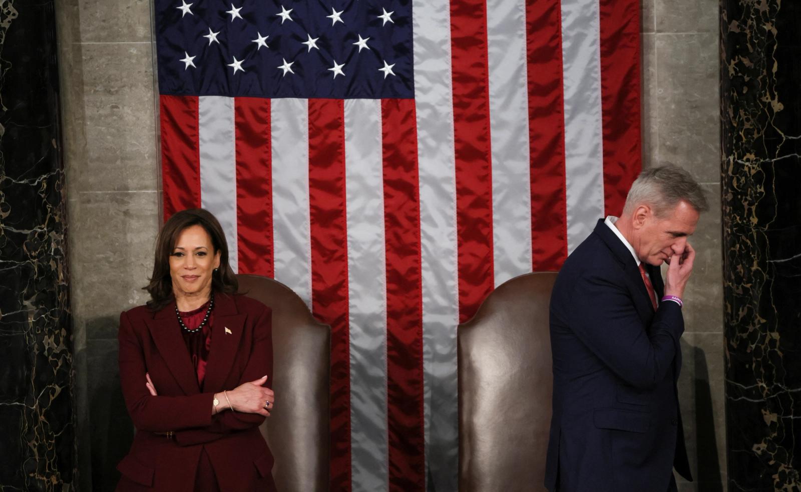 U.S. Vice President Kamala Harris and Speaker of the House Kevin McCarthy stand apart atop the dais as President Joe Biden works the crowd on his way out after the conclusion of his State of the Union address before a joint session of Congress in the House Chamber at the U.S. Capitol in Washington, U.S., February 7, 2023.