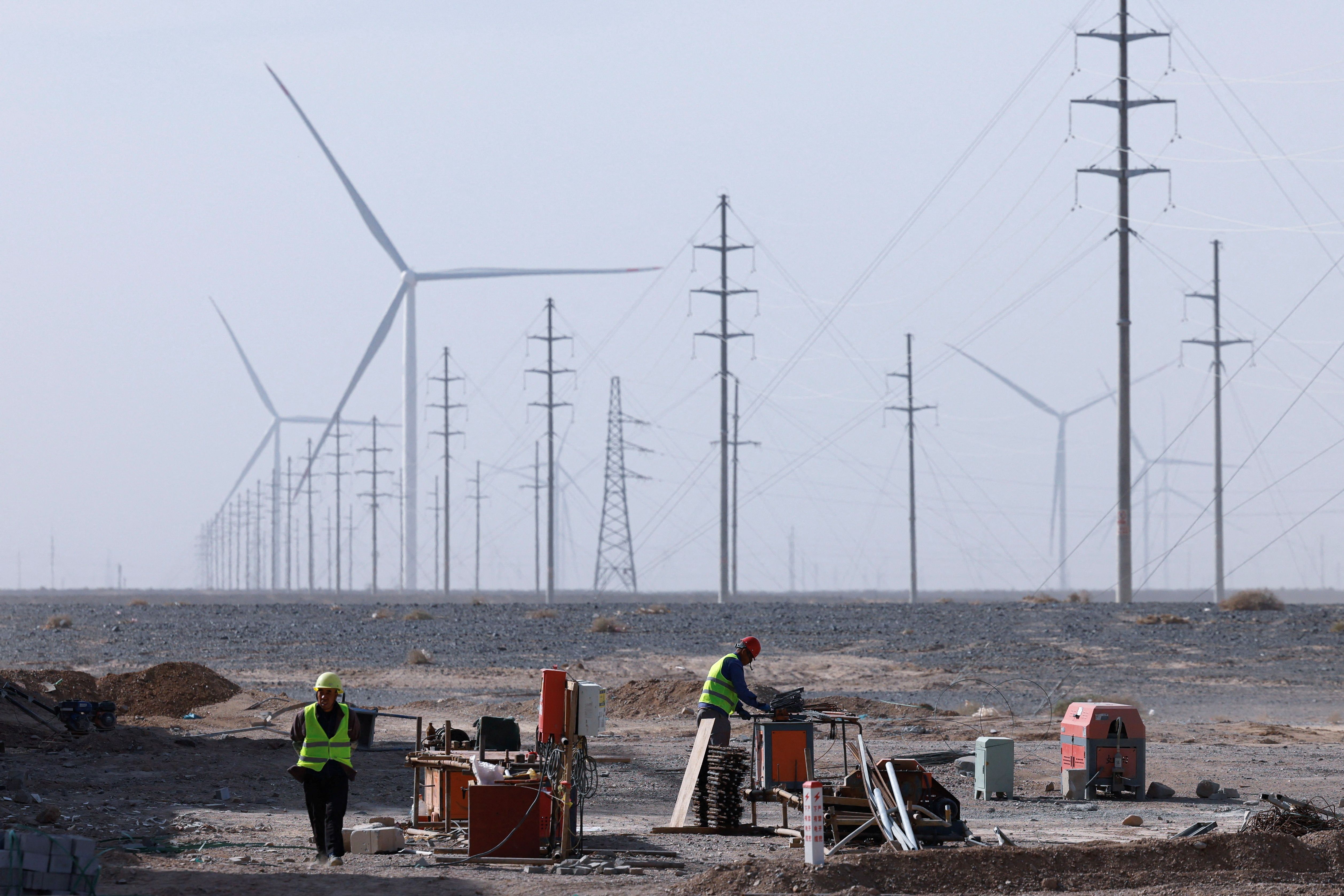 Workers work at a construction site at a Taiyuan New Energy Co wind farm, China.