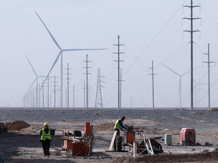 Workers work at a construction site at a Taiyuan New Energy Co wind farm, China.
