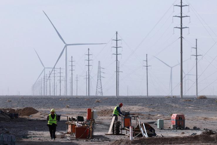 Workers work at a construction site at a Taiyuan New Energy Co wind farm, China.