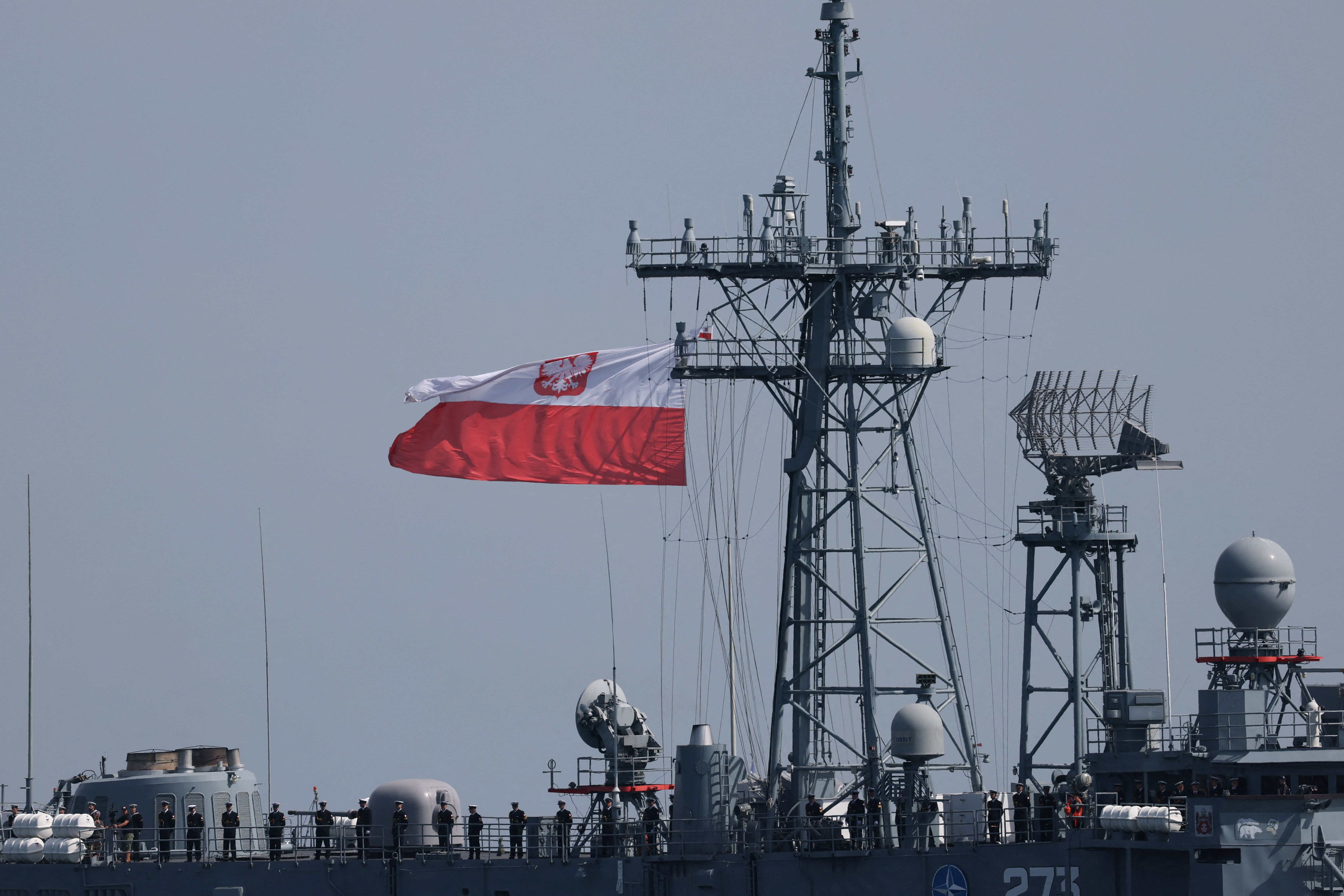 Polish Navy soldiers stand guard on Guided-missile frigate ORP General Tadeusz Kosciuszko as they take part in a naval parade on Armed Forces Day, commemorating Poland’s victory over the Soviet Red Army in 1920.