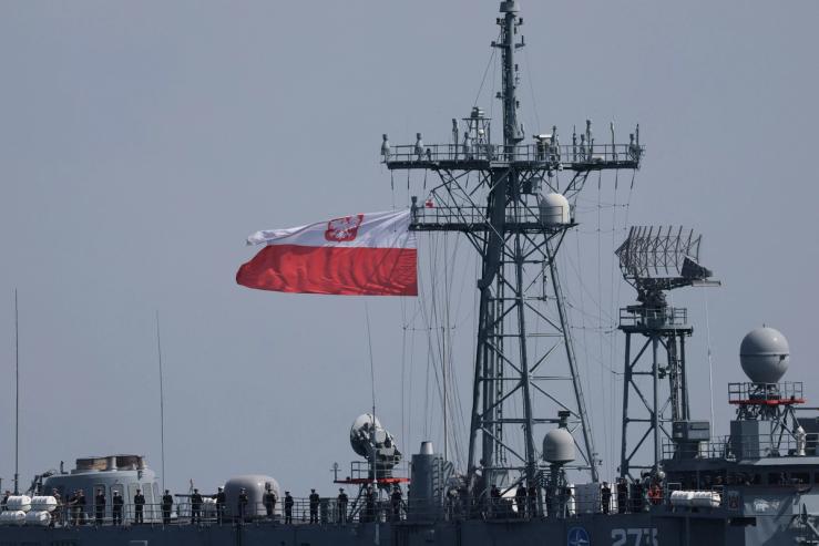 Polish Navy soldiers stand guard on Guided-missile frigate ORP General Tadeusz Kosciuszko as they take part in a naval parade on Armed Forces Day, commemorating Poland’s victory over the Soviet Red Army in 1920.