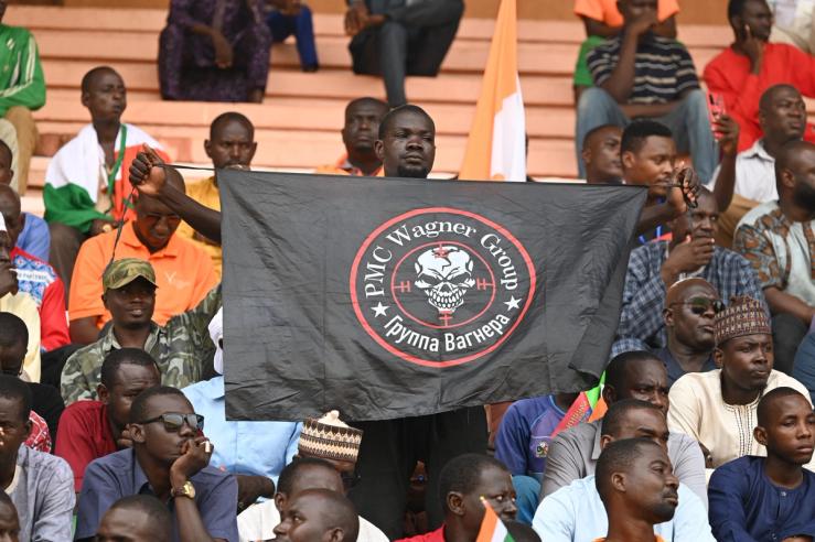 A man holds a flag bearing the Wagner logo in Niamey, Niger, on August 26, 2023.