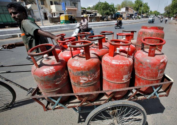 A man pulls a cart of LNG canisters