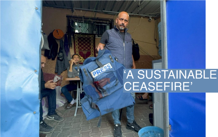 A man holds the flak jacket which belongs to Al Jazeera journalist Wael Al-Dahdouh, who was wounded, amid the ongoing conflict between Israel and the Palestinian Islamist group Hamas, in Khan Younis in the southern Gaza Strip, December 15, 2023. REUTERS/Bassam Masoud