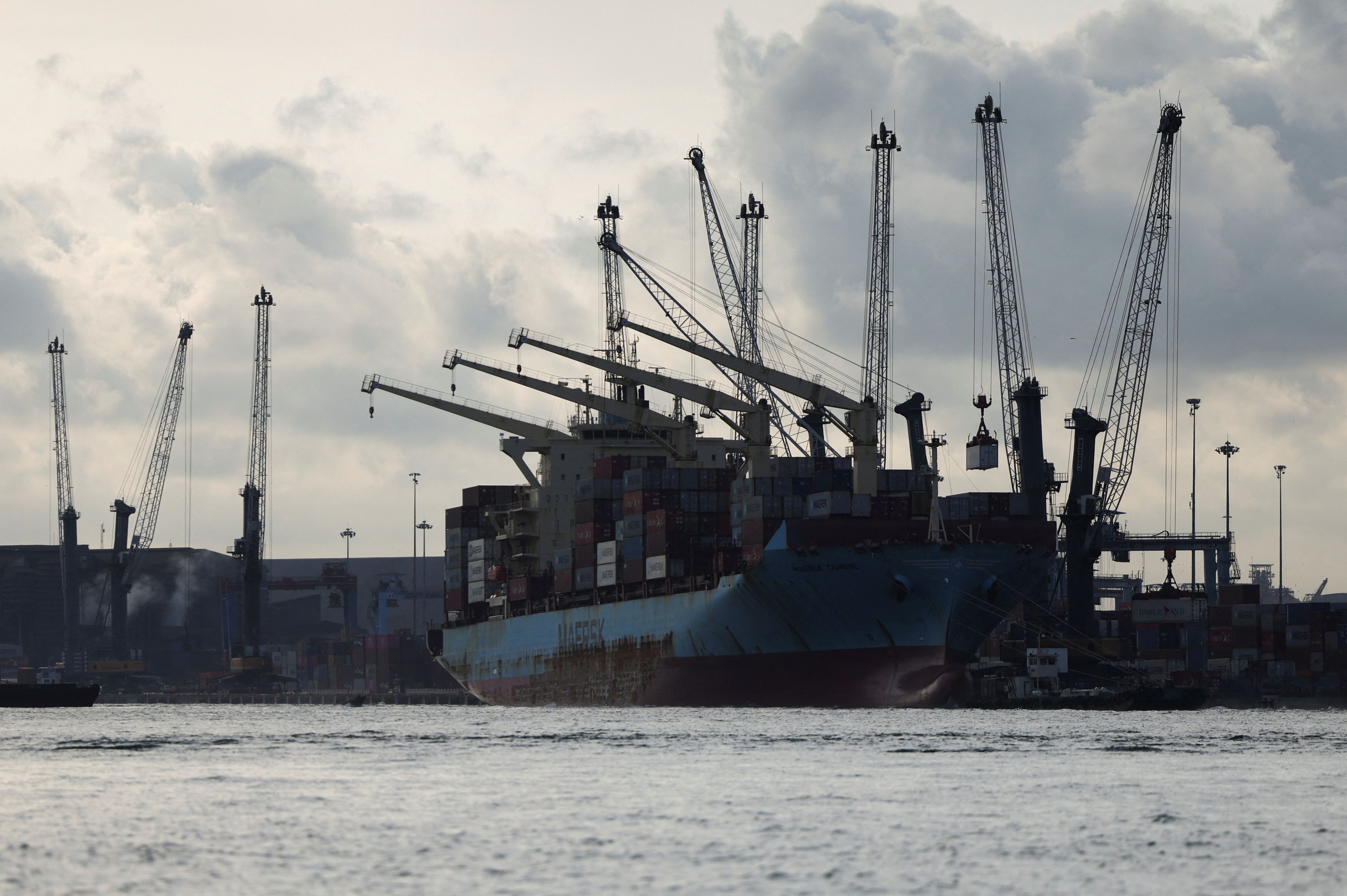 Container ship carrying cargo docks in Lagos, Nigeria.