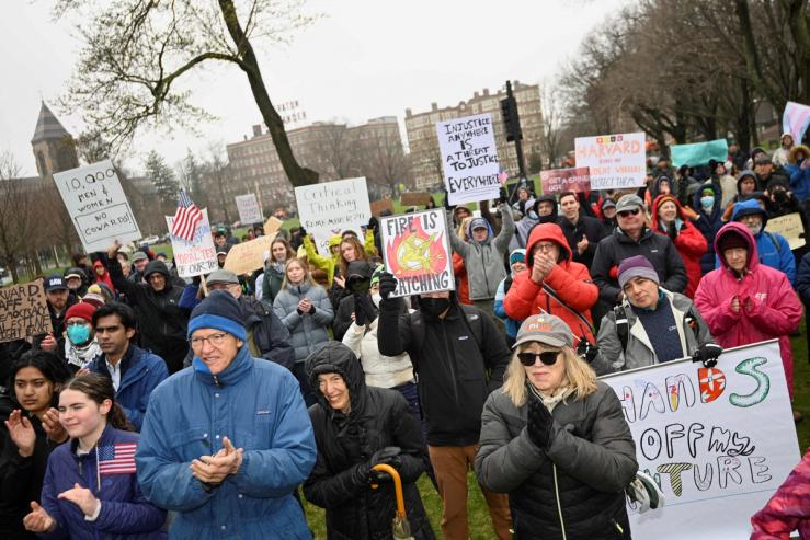 Protestors gather in Cambridge to oppose the federal government’s actions against Harvard.
