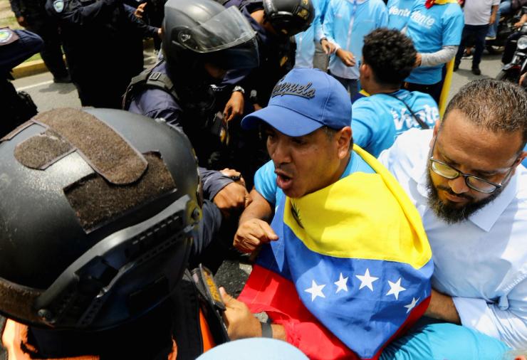 Demonstrators argue with police officers during a rally in support of Venezuelan opposition leader Maria Corina Machado.