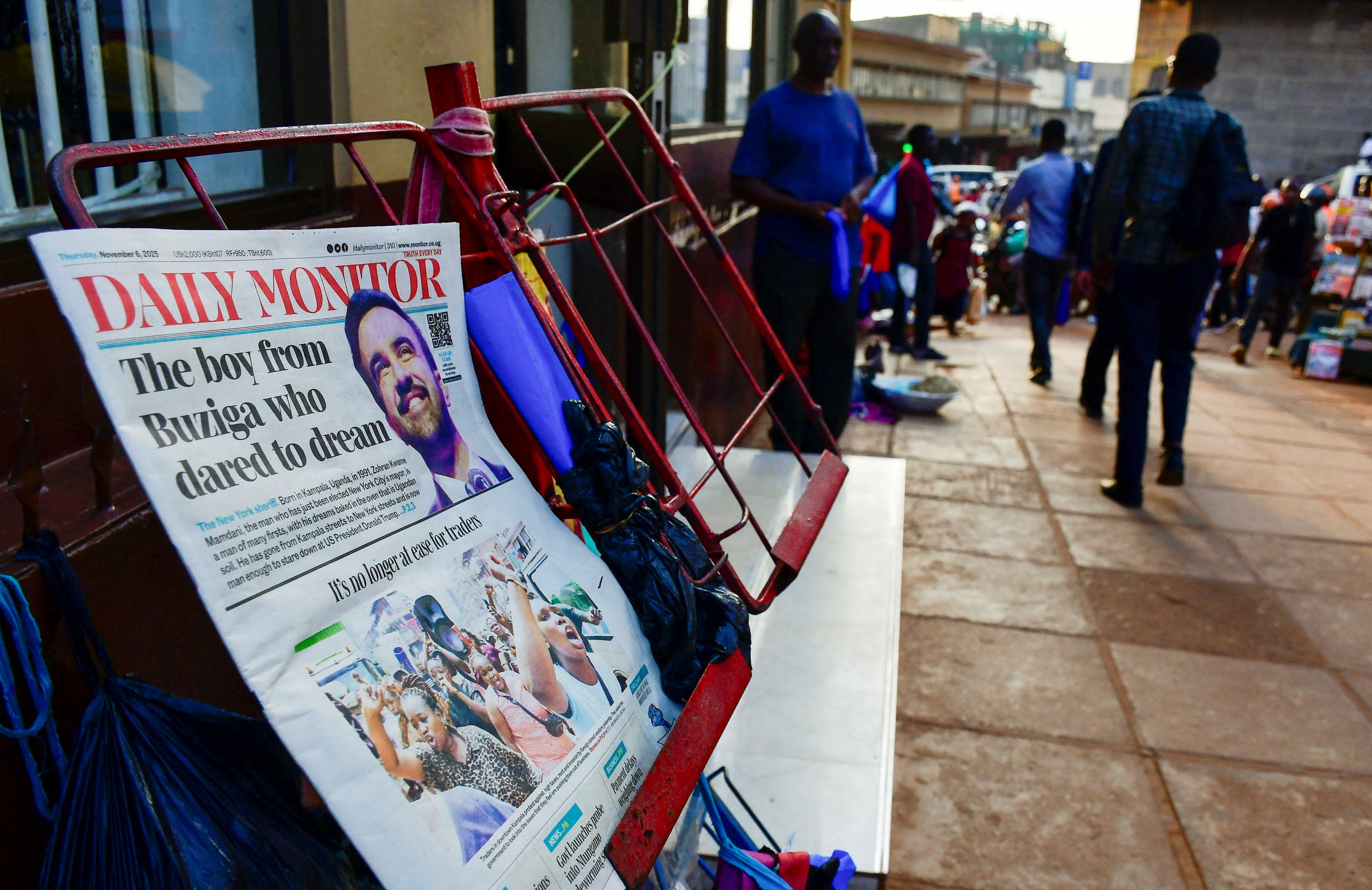 A copy of Daily Monitor newspaper is on display along a street in Kampala.