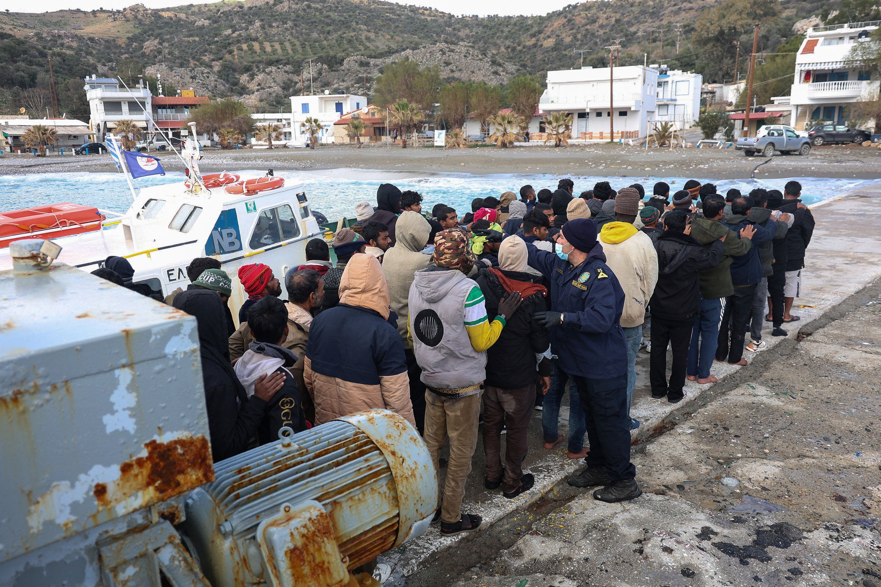 Migrants stand in line in Crete