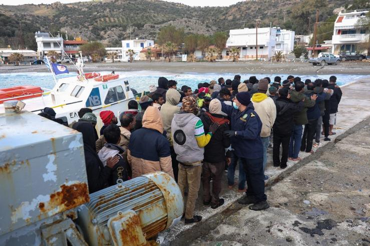 Migrants stand in line in Crete