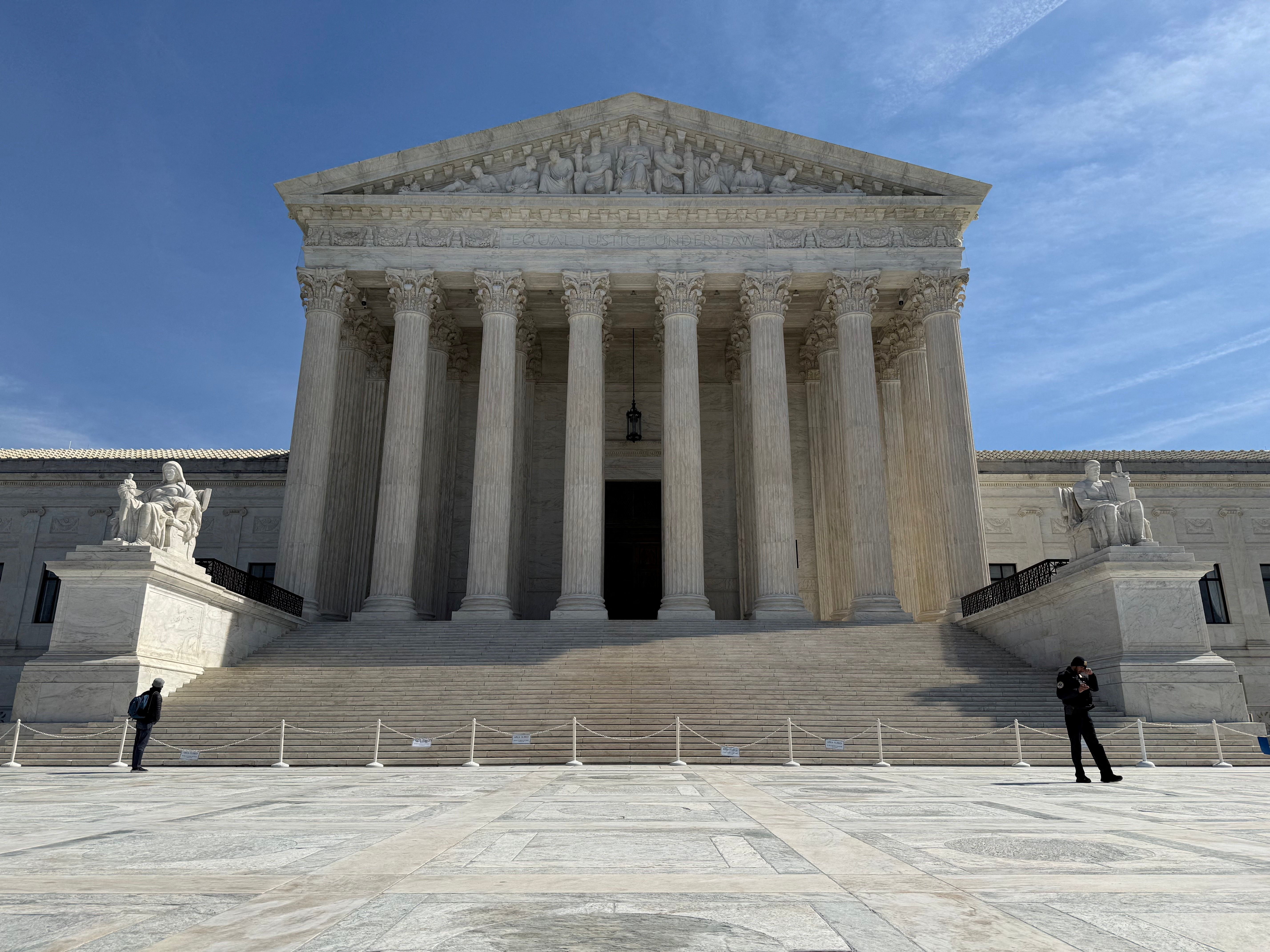 People walk outside the US Supreme Court building