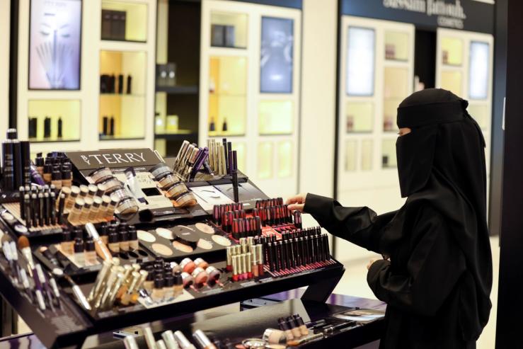 A Saudi woman buys makeup from a cosmetic shop in Centria Mall in Riyadh, Saudi Arabia.