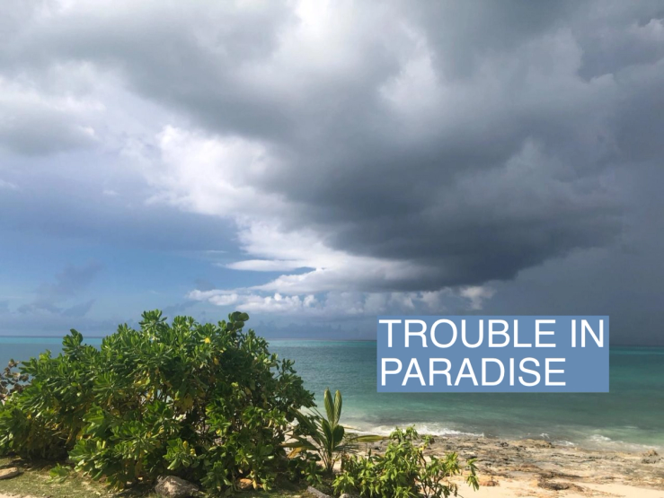 A storm cloud hangs over a beach in the Bahamas