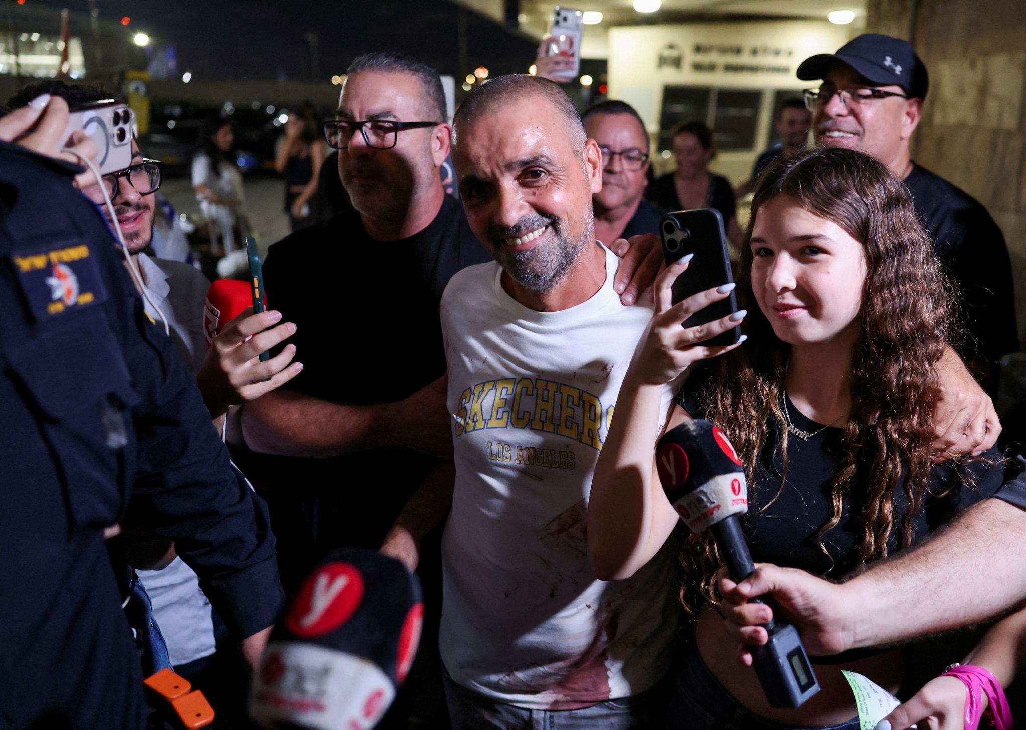 Passengers from a FlyDubai flight to Israel from the United Arab Emirates that was diverted to Saudi Arabia after an emergency signal arrive at Ben Gurion International Airport
