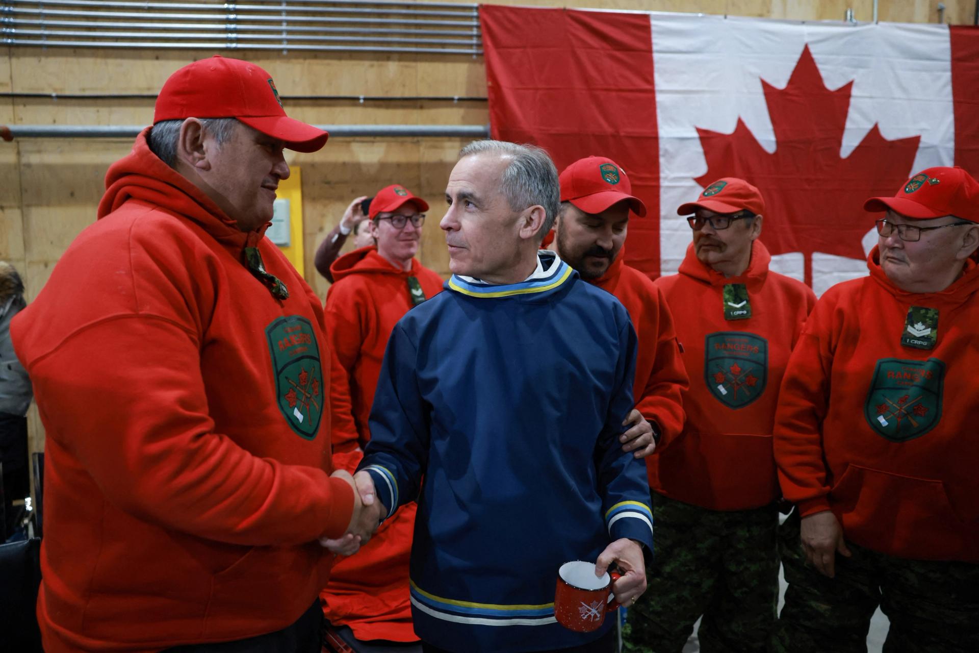 Canada’s Prime Minister Mark Carney shakes hands with a Canadian Ranger.