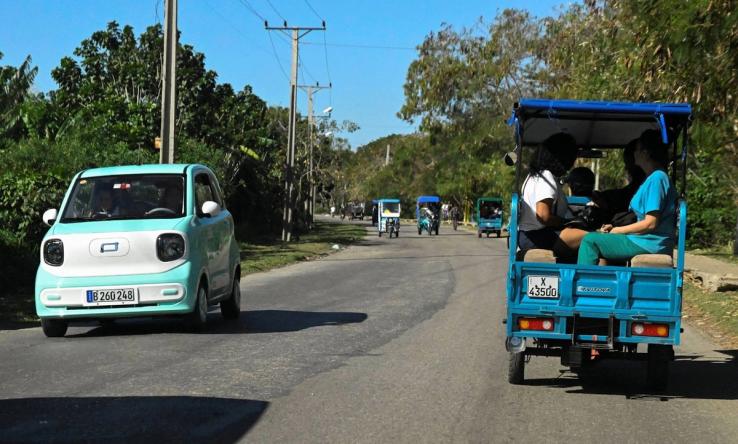 People riding in EVs in Cuba.