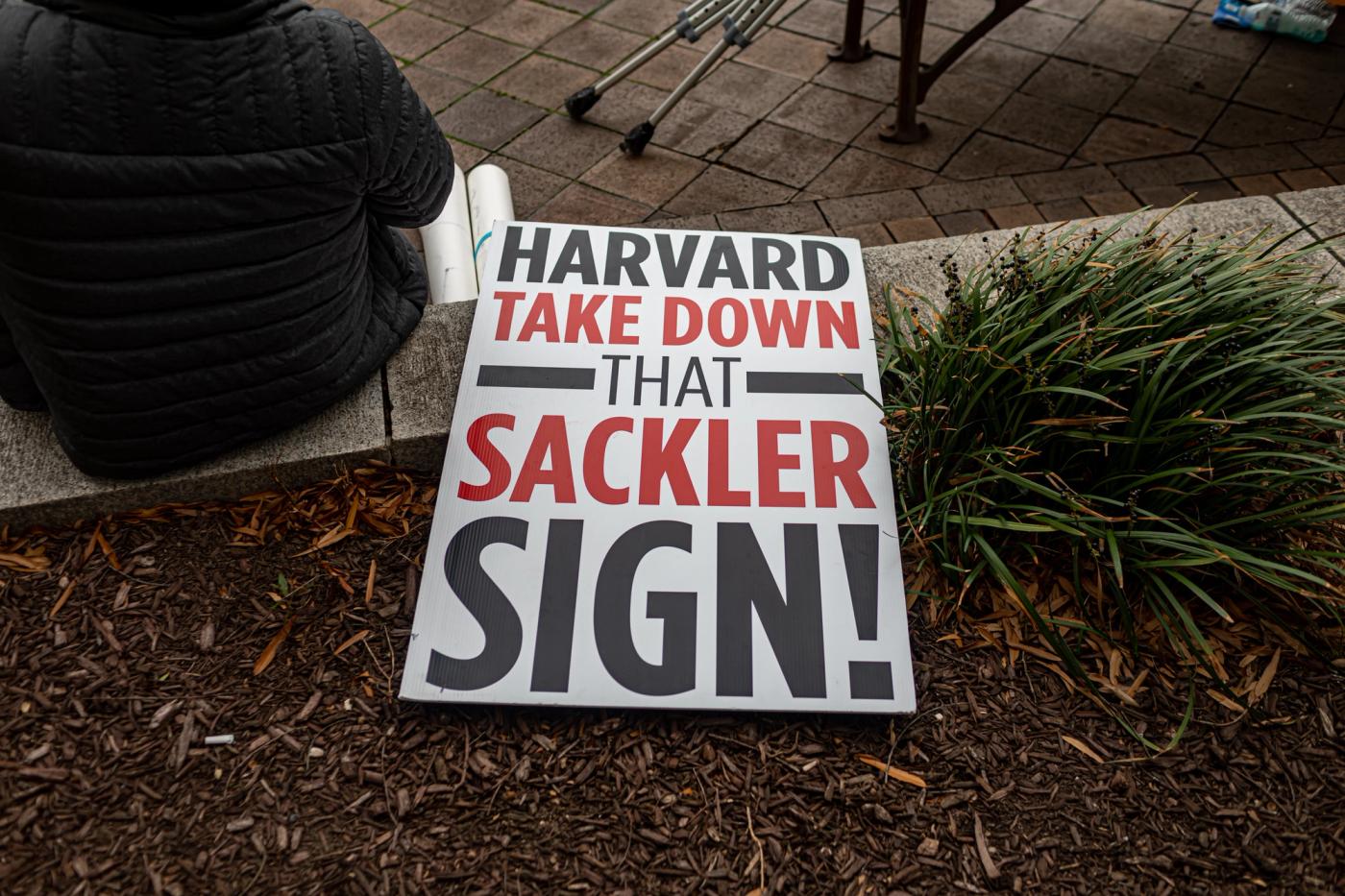 A sign at a protest calling for Harvard to remove its ties to the Sacklers.
