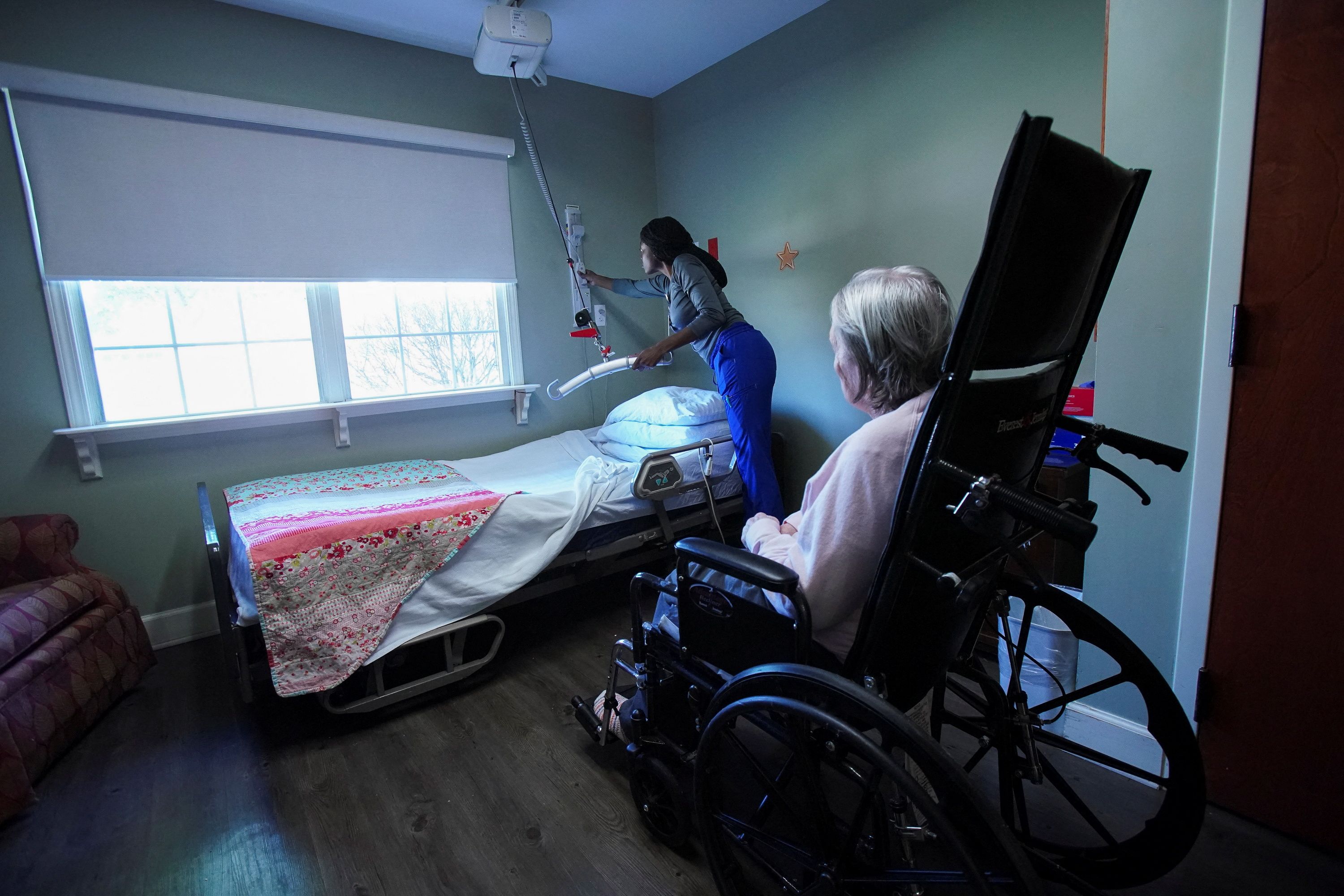 Brianna Reed cares for Bessie Pugh, 90, an Alzheimer’s patient at the Ave Maria Home.