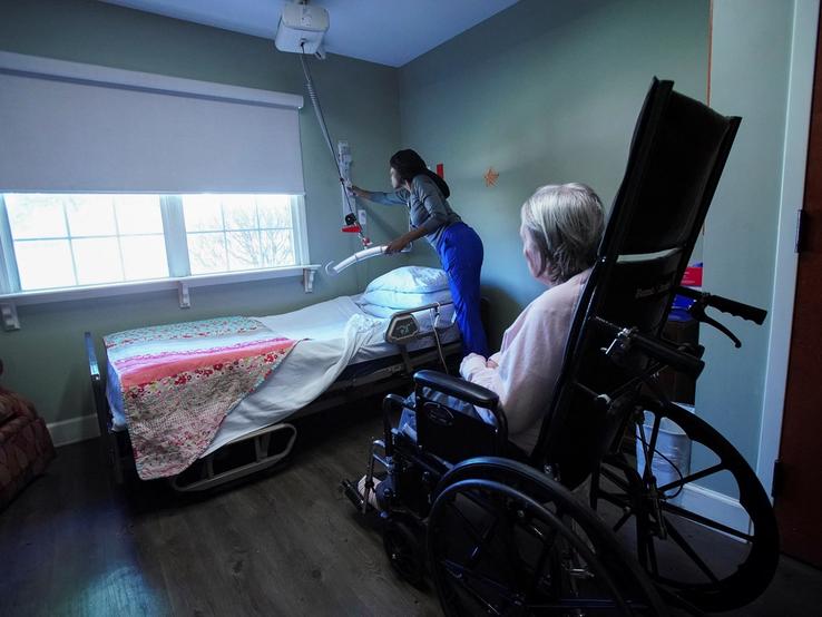 Brianna Reed cares for Bessie Pugh, 90, an Alzheimer’s patient at the Ave Maria Home.