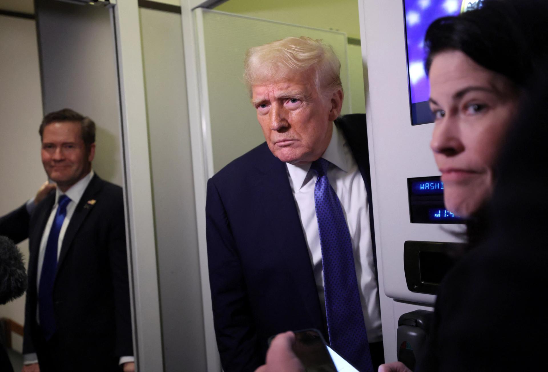 Donald Trump speaks to reporters onboard Air Force One on his return to Washington, DC. 