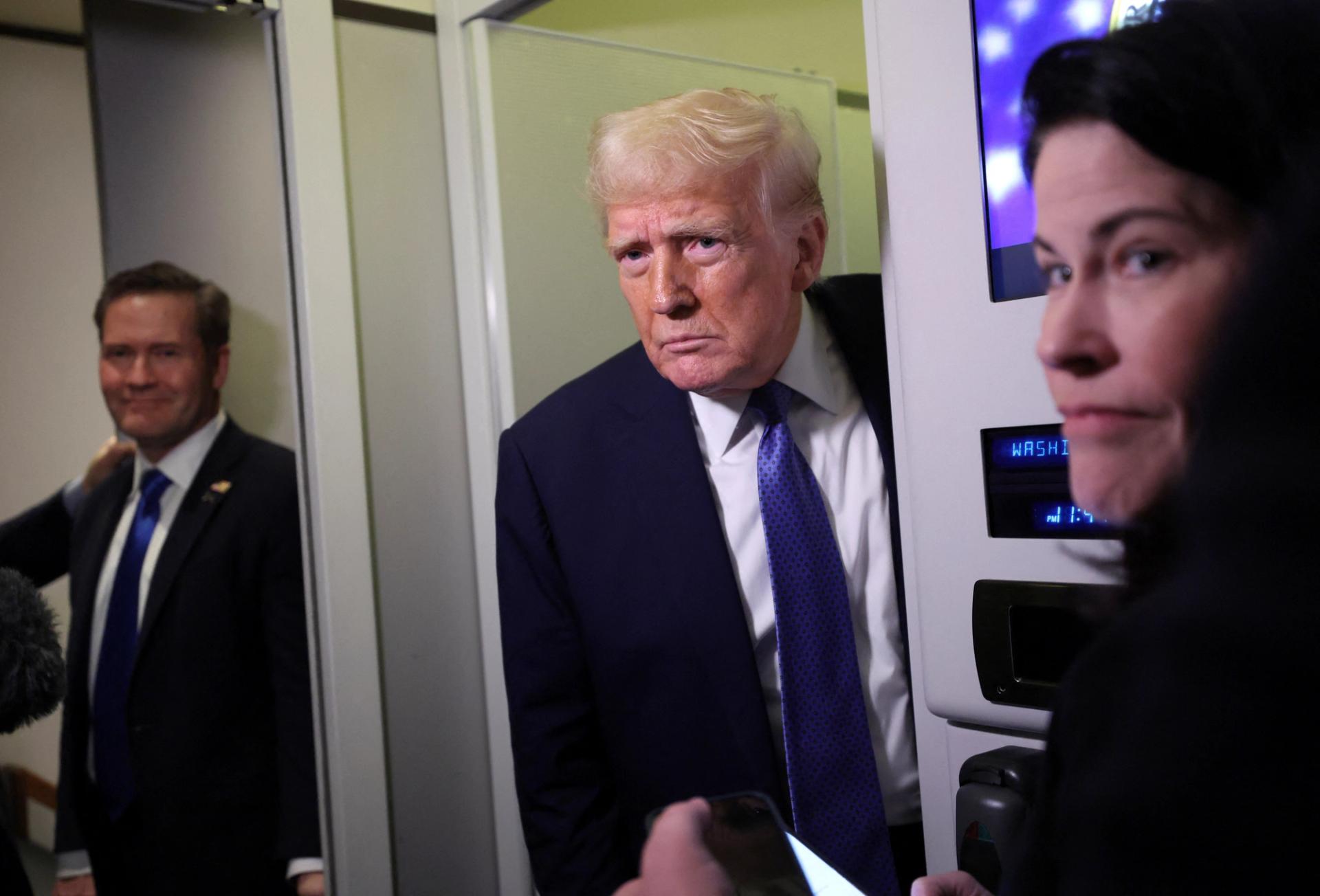 Donald Trump speaks to reporters onboard Air Force One on his return to Washington, DC.