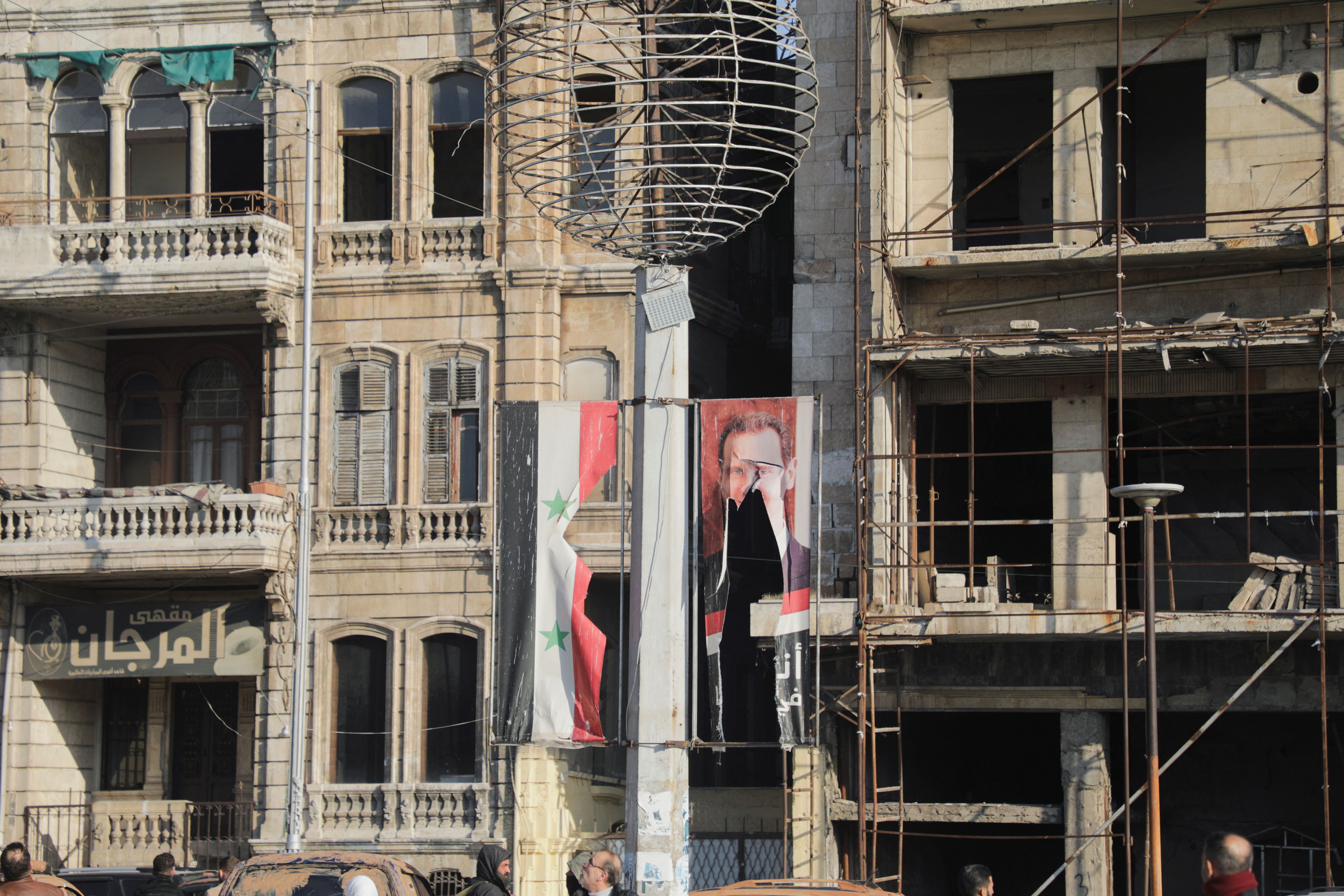 A torn poster of President Bashar al-Assad in Aleppo.