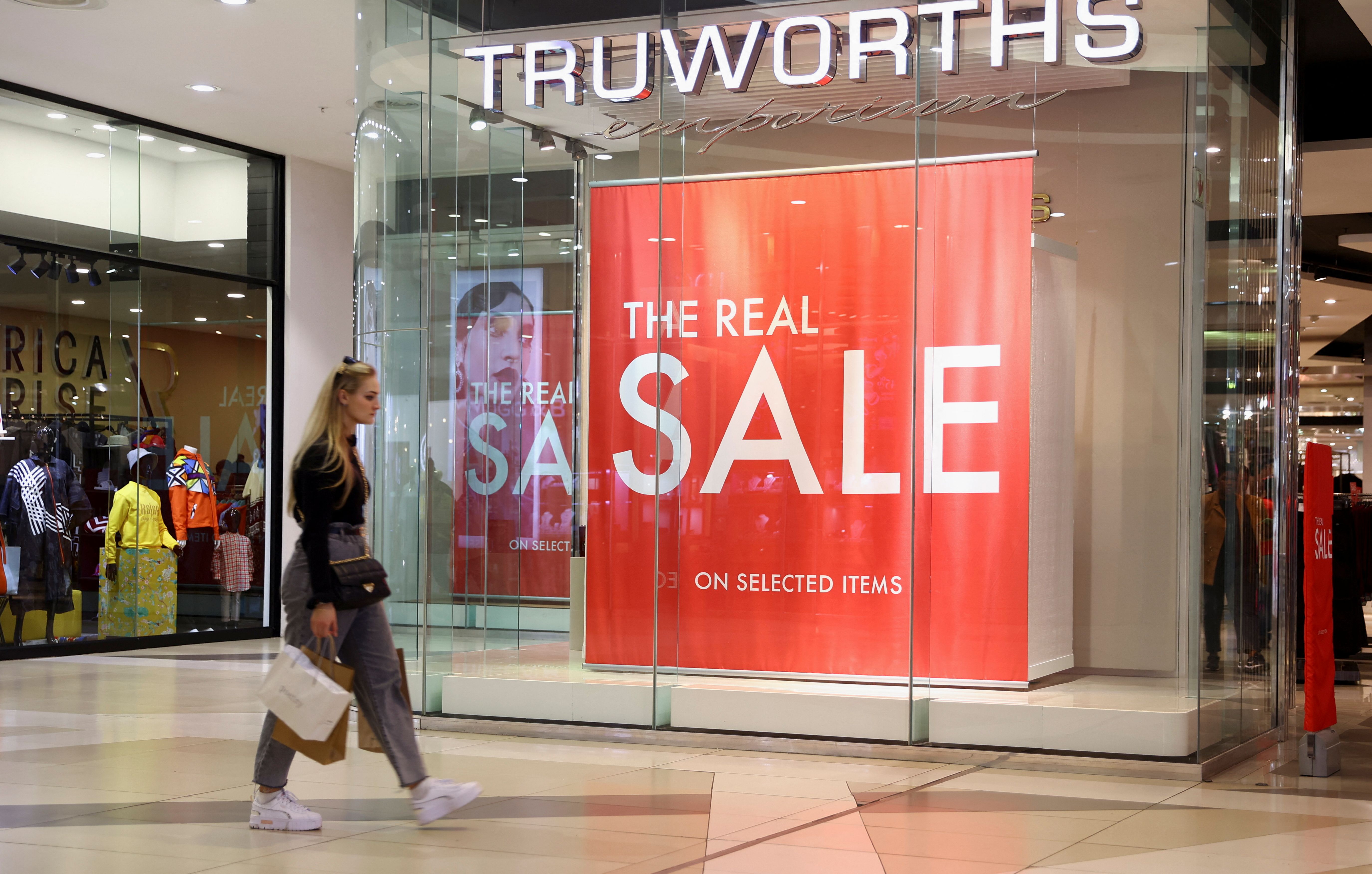 A shopper walks past a Truworths shop in Johannesburg.