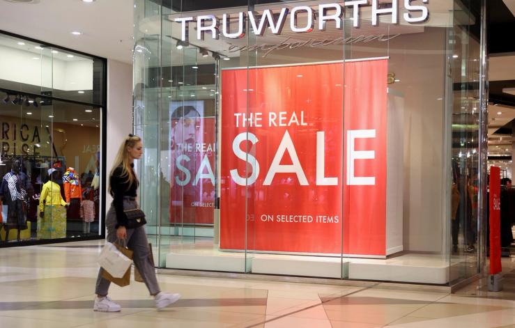 A shopper walks past a Truworths shop in Johannesburg.