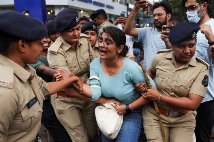 A demonstrator reacts as police detain her during a protest organised by supporters of India’s Cockroach Janta Party