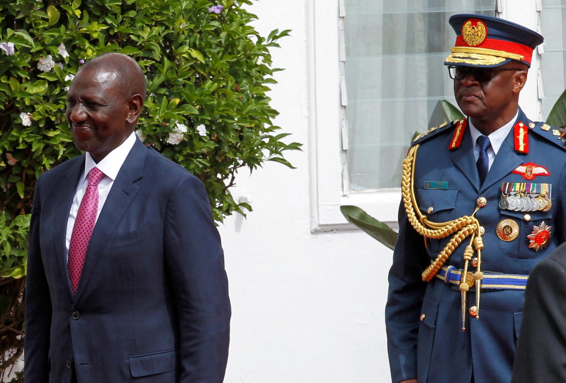 Kenya's President William Ruto is escorted by Francis Ogolla (R), Chief of Kenya Defence Forces. 