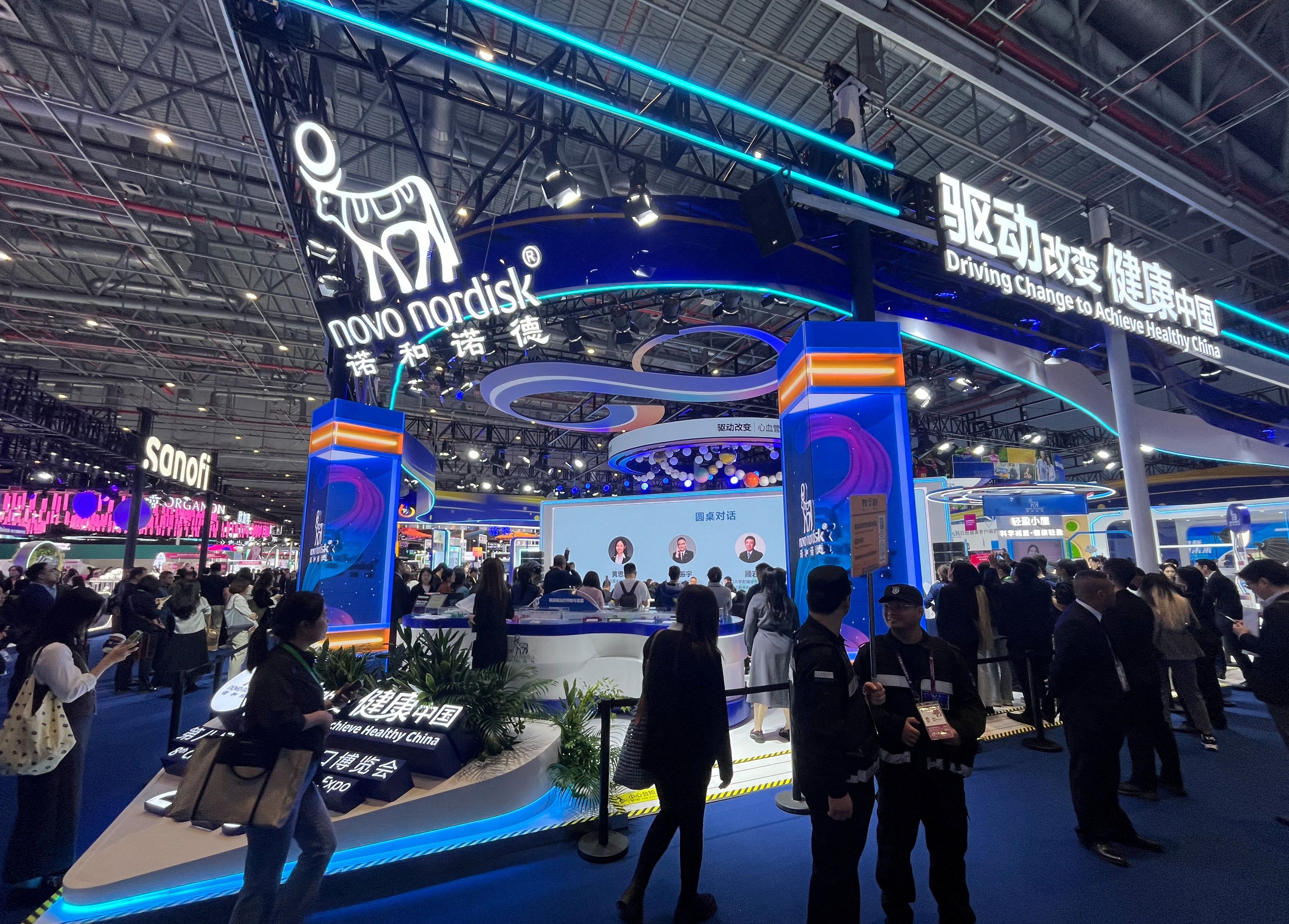 People walk past the Novo Nordisk booth at the 8th China International Import Expo (CIIE) in Shanghai