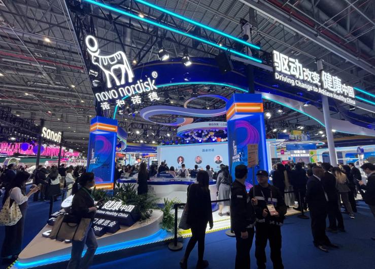 People walk past the Novo Nordisk booth at the 8th China International Import Expo (CIIE) in Shanghai