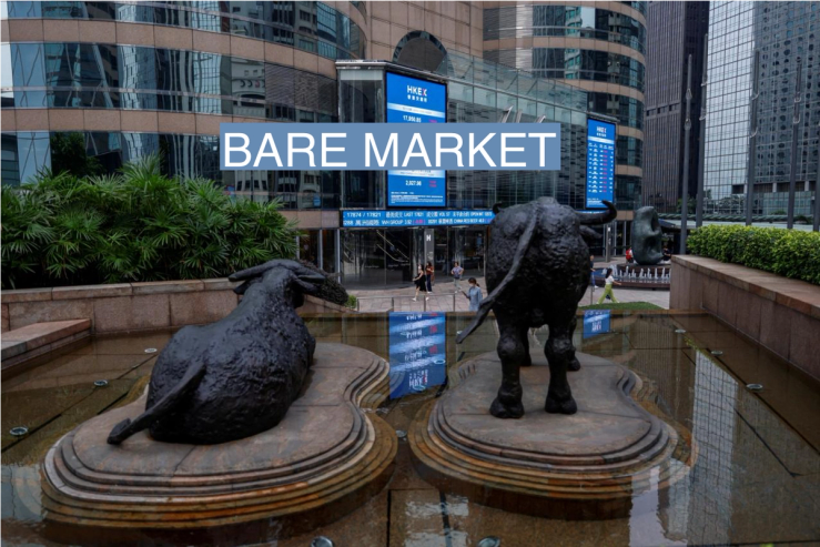 Bull statues are placed in font of screens showing the Hang Seng stock index and stock prices outside Exchange Square in Hong Kong.