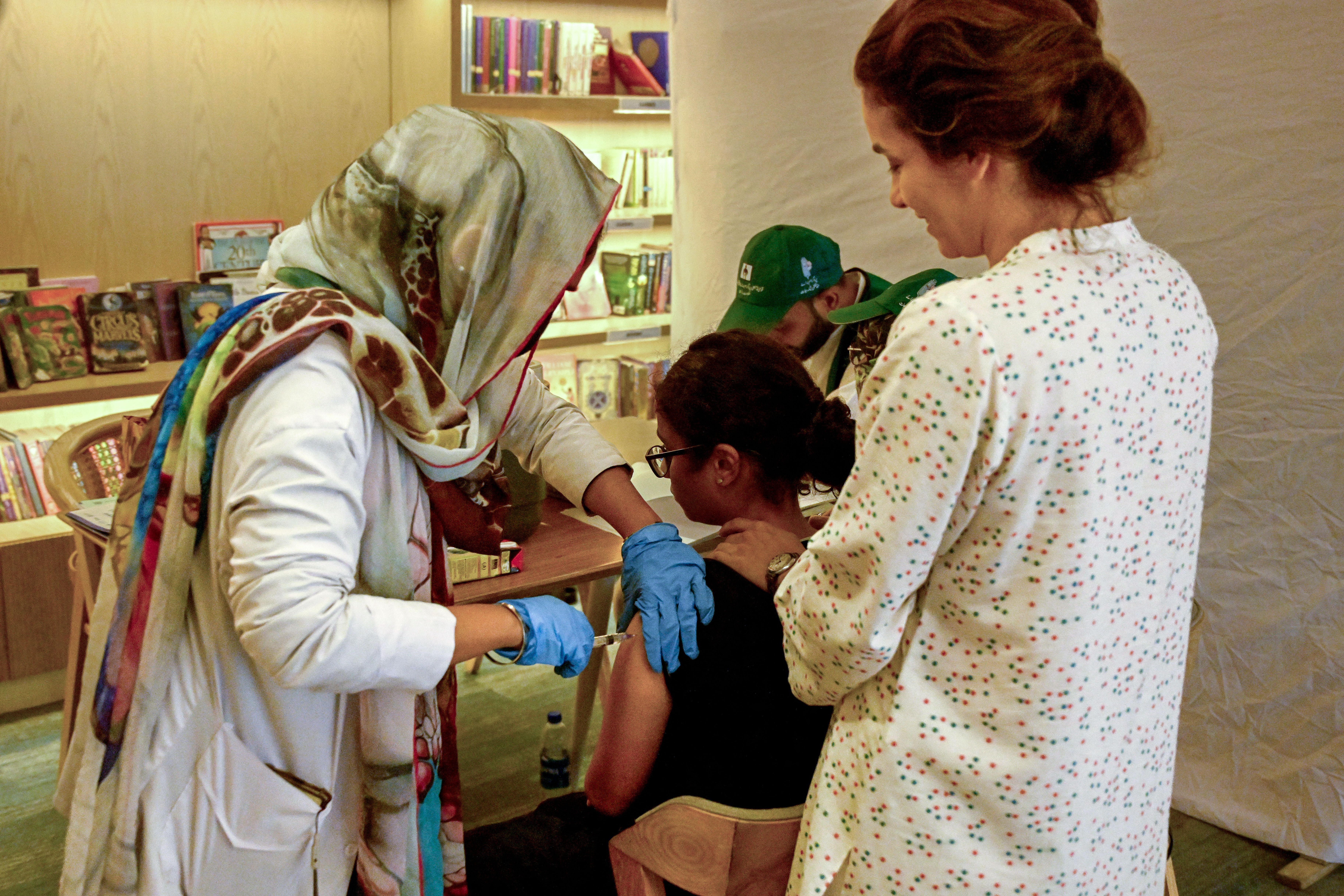 A health worker administers human papillomavirus (HPV) vaccine to a girl in Karachi on September 24, 2025, during a HPV vaccination drive against cervical cancer, most frequently diagnosed in women. 